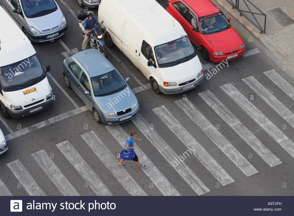 one-pedestrian-crossing-busy-road-on-zebra-crossing-with-car-traffic-A3TJFH.jpg