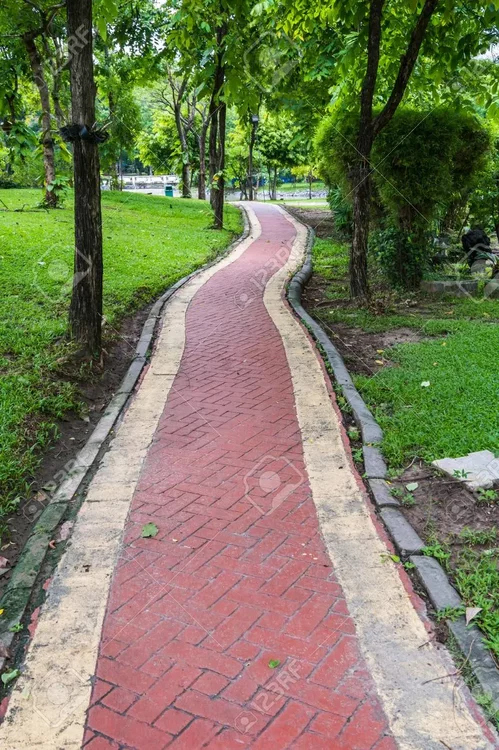 101977920-red-brick-walkway-in-green-public-park.webp